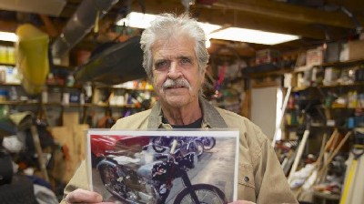 Donald DeVault poses with a photo of his stolen motorcycle Wednesday, Nov. 6, 2013, in Omaha, Neb. The 73-year-old Omaha man learned last week that California authorities had recovered his 1953 Triumph Tiger 100 at the Port of Los Angeles. The bike was about to be shipped to Japan when customs agents who checked the vehicle identification number discovered it had been reported stolen in February 1967. The bike will be shipped back to DeVault in Omaha.